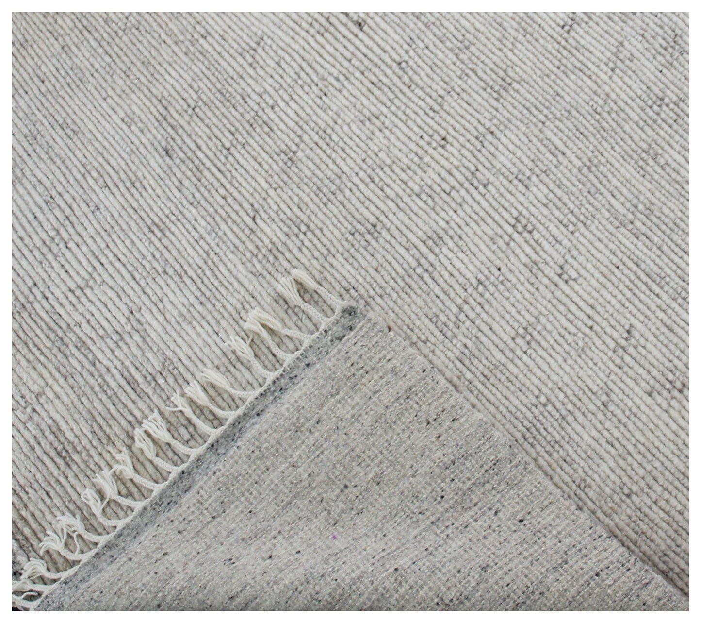 Gray textured rug with a subtle pattern and fringed edge