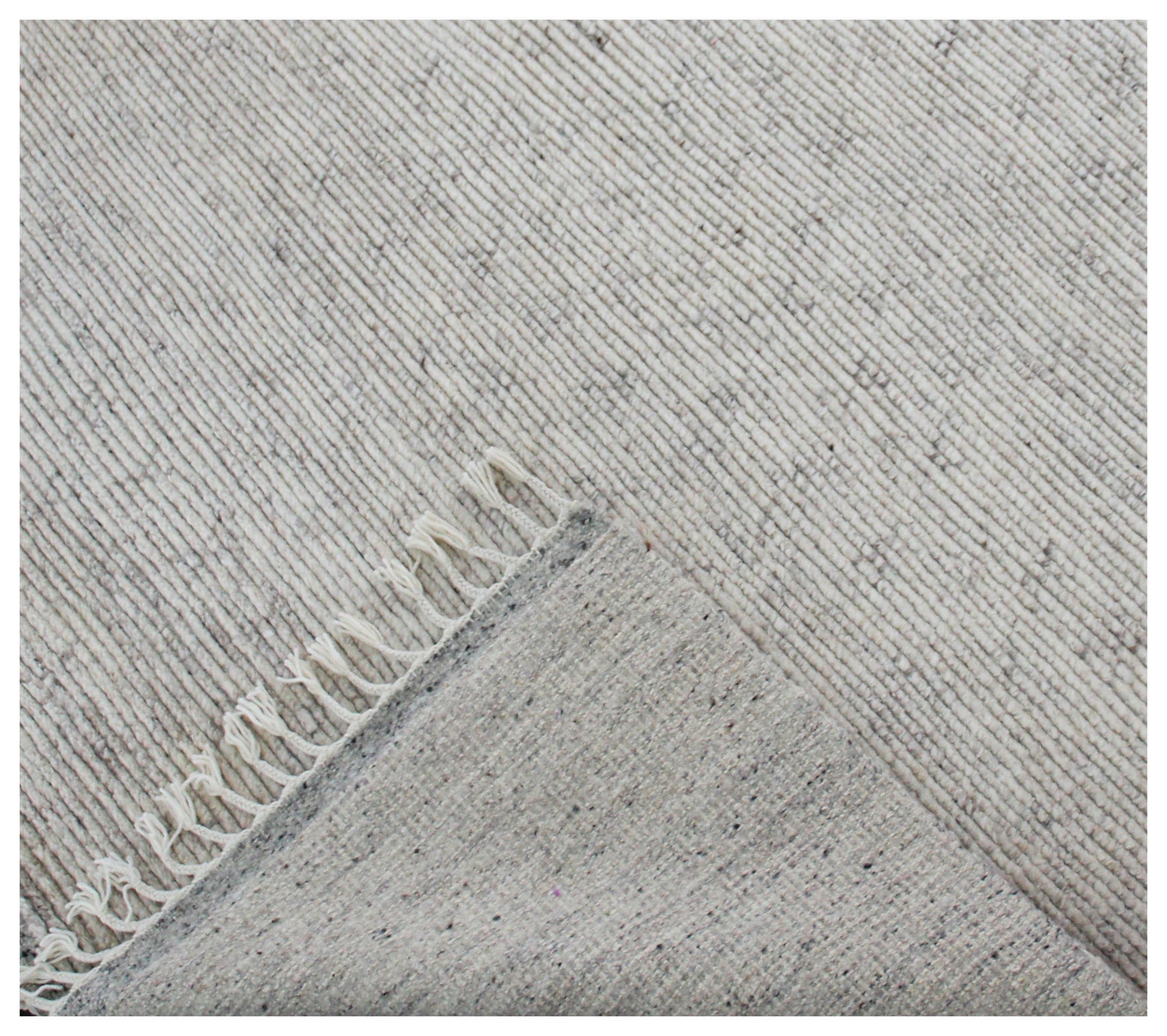 Gray textured rug with a subtle pattern and fringed edge