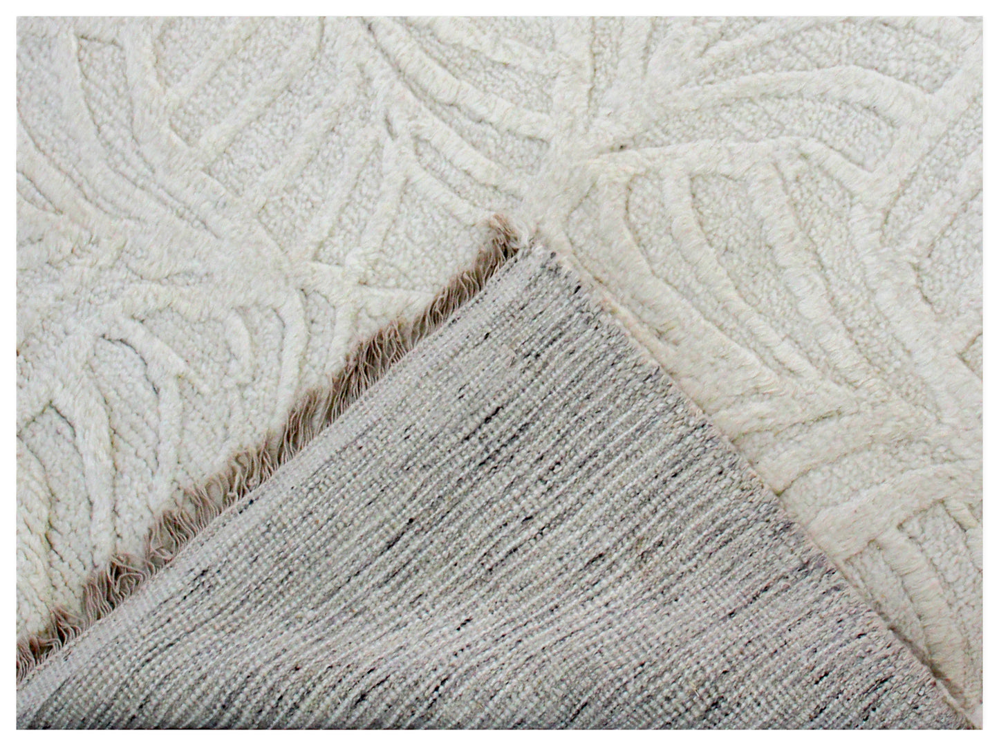 Close-up of textured beige and white rug corner