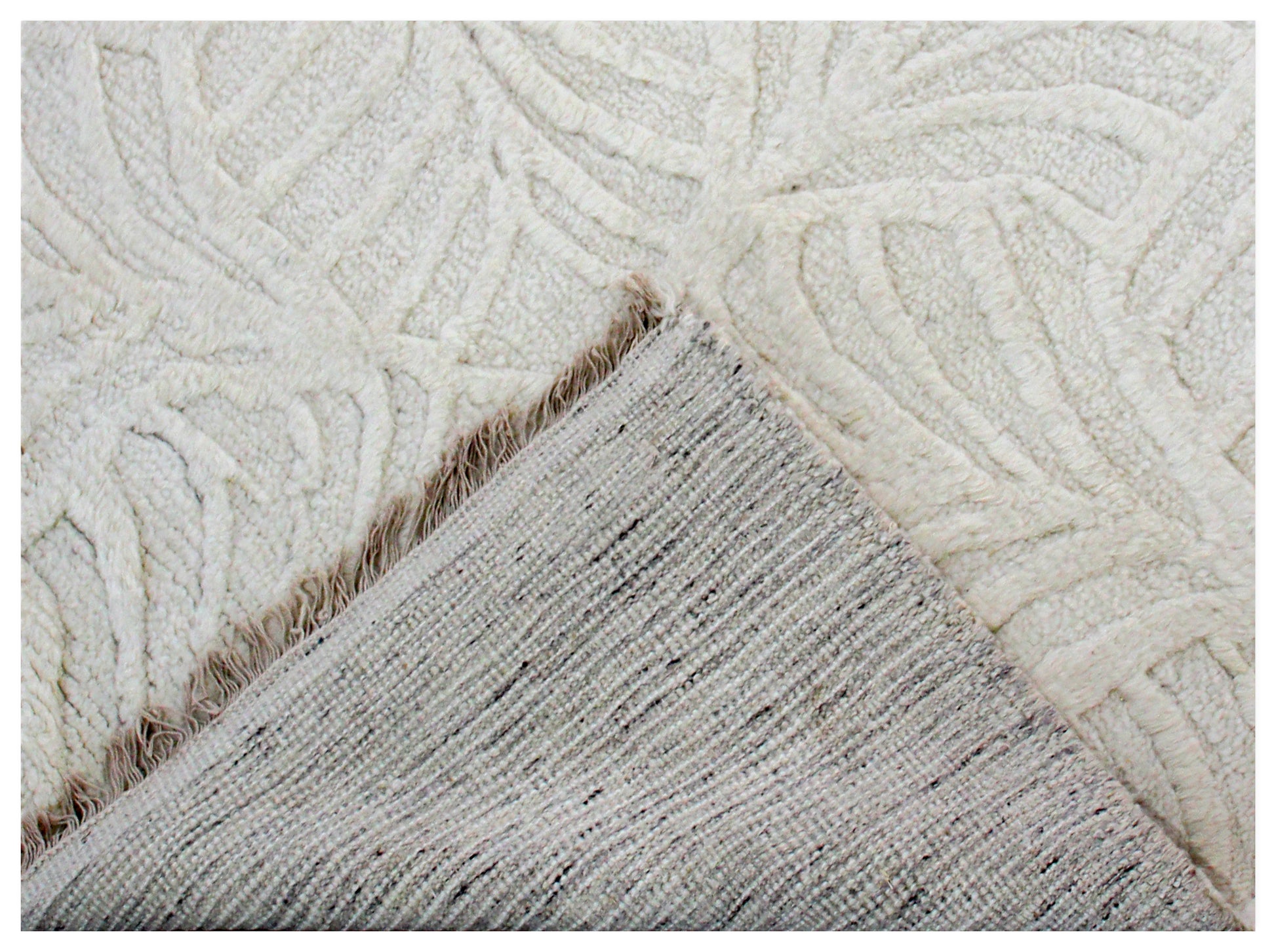 Close-up of textured beige and white rug corner