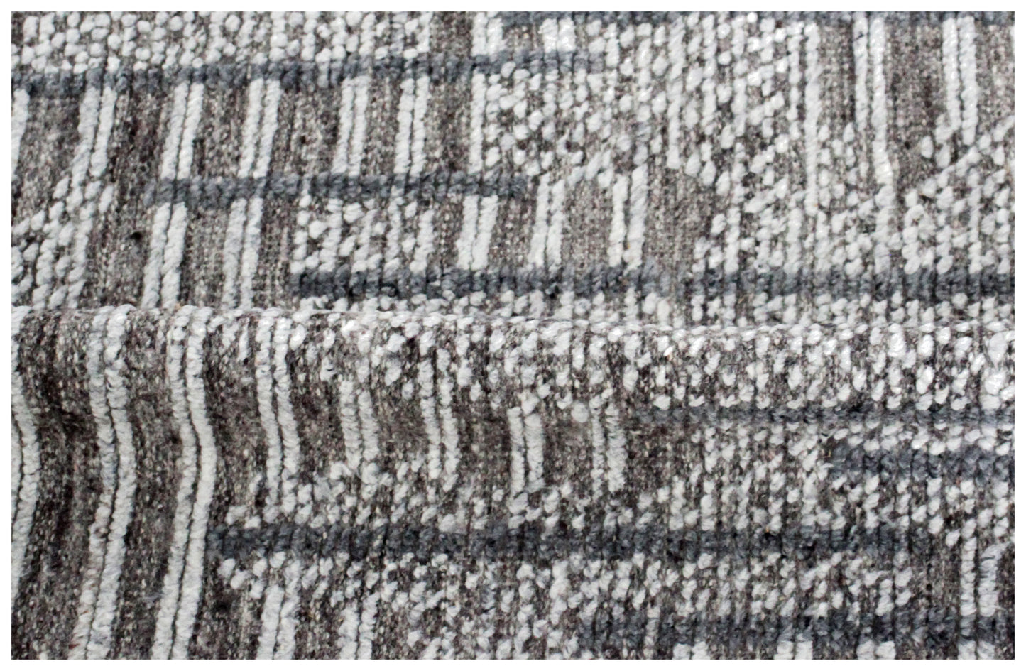 Textured fabric with a plaid pattern in brown, gray, and white.