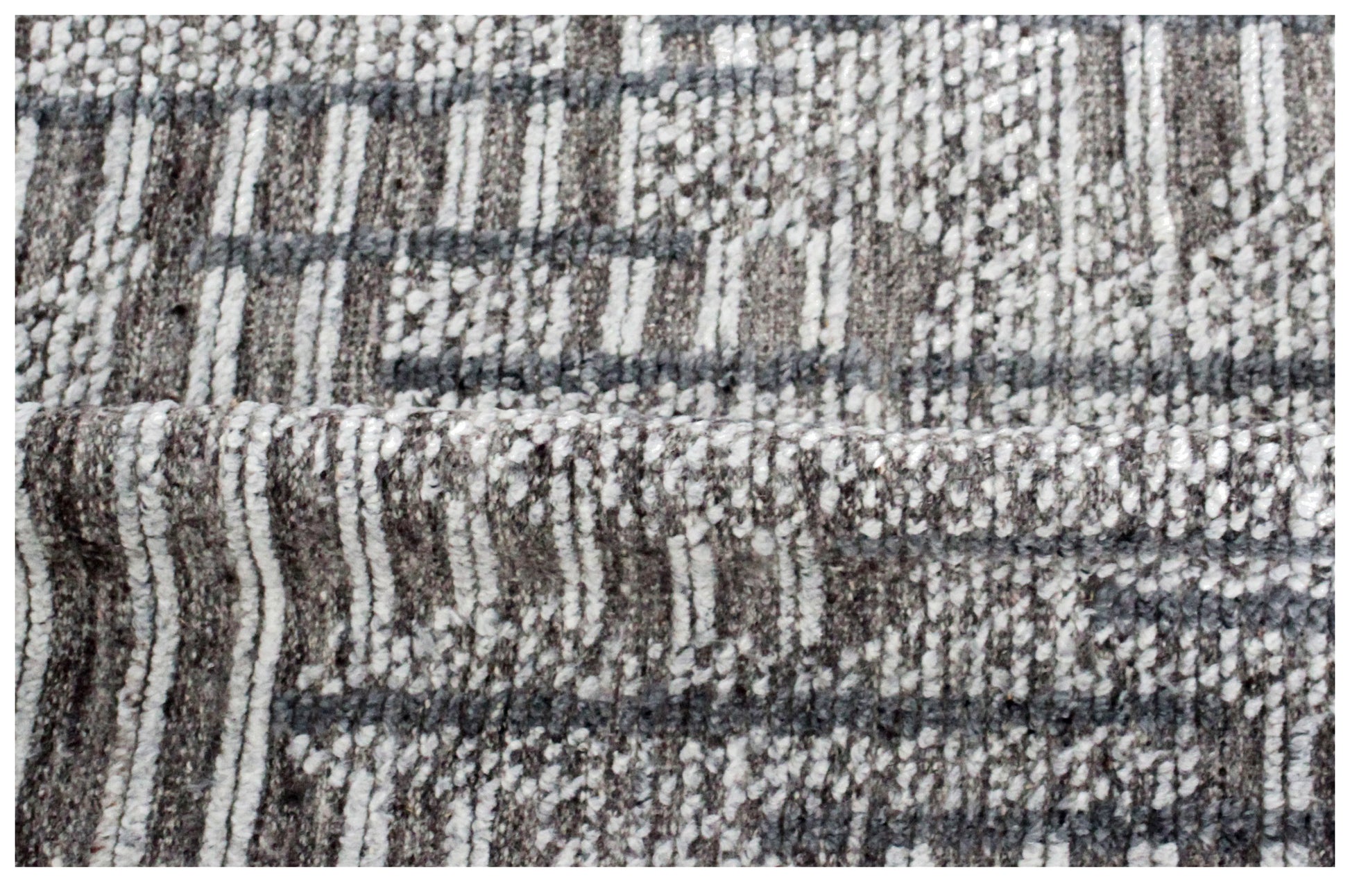 Textured fabric with a plaid pattern in brown, gray, and white.