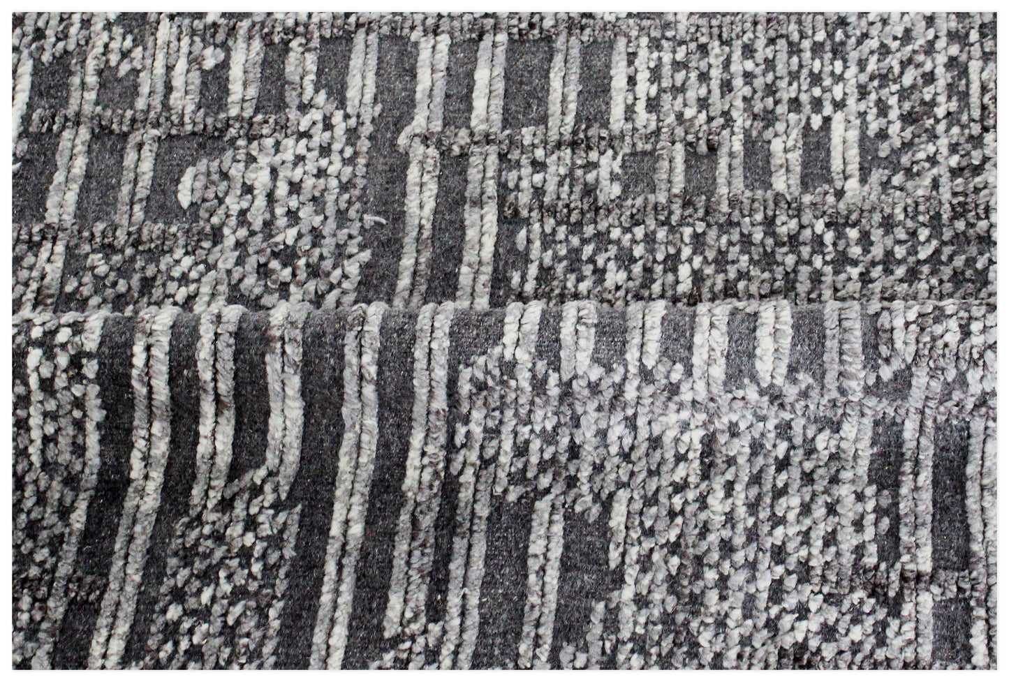 Textured fabric with a pattern of black, white, and gray lines and dots.